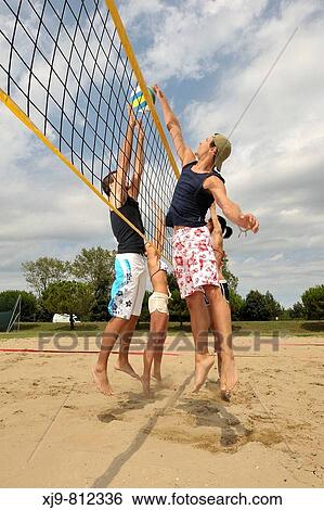 Boys playing beach volleyball. View Large Photo Image Stock Photograph - Boys playing beach volleyball.. Fotosearch