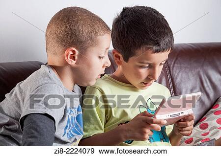 Stock Photo - Boys playing computer game.. Fotosearch