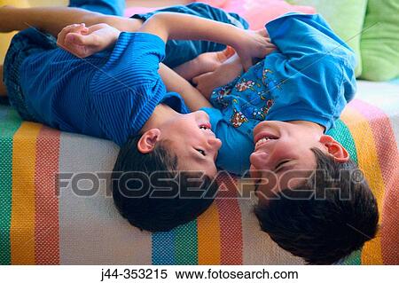 Stock Photography - Boys playing on bed. Fotosearch