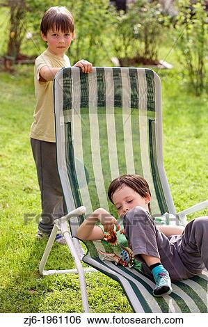Boys playing outdoor in the garden. View Large Photo Image Stock Photograph - Boys playing outdoor in the garden.. Fotosearch