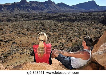 Boys sitting watching the valley of the volcano Teide. View Large Photo Image Stock Image - Boys sitting watching the valley of the volcano Teide.. Fotosearch