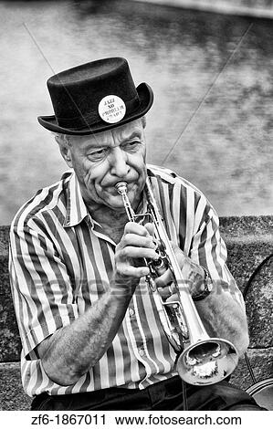 Stock Image - Brass polka band performing on the famous Charles Bridge of tourist city of Prague in Czech Republic. Fotosearch
