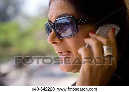 Stock Image - Brazil, Rio de Janeiro, woman on cell phone. Fotosearch
