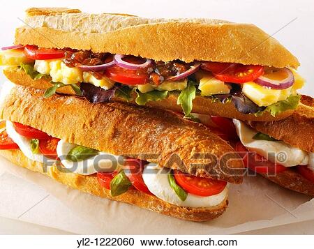 Bread baguettes filled with mozerella & tomatoes, and cheddar ploughmans with chutney View Large Photo Image Stock Image - Bread baguettes filled with mozerella & tomatoes, and cheddar ploughmans with chutney. Fotosearch