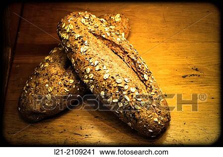 Stock Image - Bread on wooden background.. Fotosearch