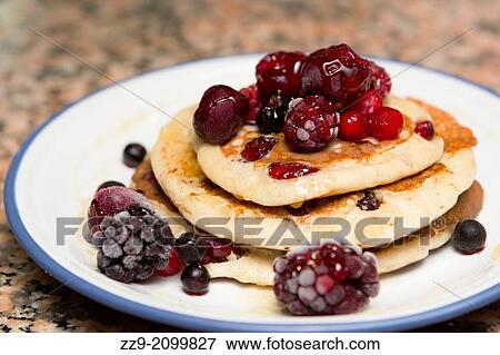 Stock Photo - Breakfast of pancakes with berries.. Fotosearch