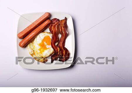 Breakfast with eggs, bacon and sausages View Large Photo Image Stock Photo - Breakfast with eggs, bacon and sausages. Fotosearch