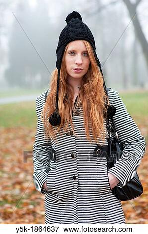 Breda, Netherlands. Young, fashionable and redheaded woman in a city-park. View Large Photo Image Stock Photo - Breda, Netherlands. Young, fashionable and redheaded woman in a city-park.. Fotosearch
