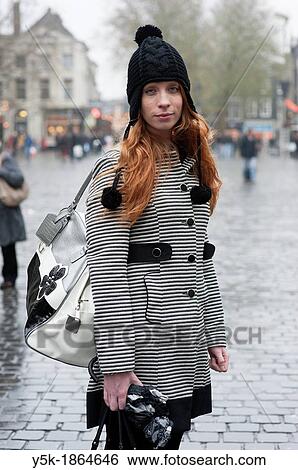 Breda, Netherlands. Young, fashionable and redheaded woman, standing on a city square. View Large Photo Image Stock Photograph - Breda, Netherlands. Young, fashionable and redheaded woman, standing on a city square.. Fotosearch