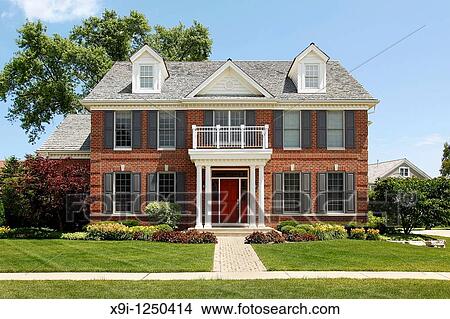 Picture - Brick home with columned entry and front balcony. Fotosearch