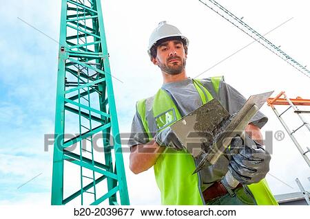 Bricklayer applying cement mortar with a trowel. Construction of residential building. Donostia. San Sebastian. Gipuzkoa. Basque Country. Spain. View Large Photo Image Stock Photo - Bricklayer applying cement mortar with a trowel. Construction of residential building. Donostia. San Sebastian. Gipuzkoa. Basque Country. Spain.. Fotosearch