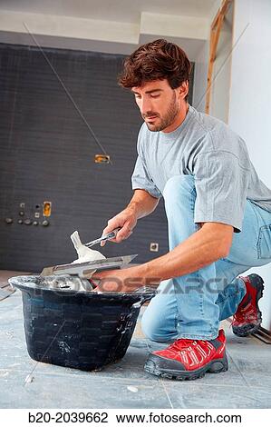 Bricklayer applying tile adhesive for tiling. Construction of residential building. Donostia. San Sebastian. Gipuzkoa. Basque Country. Spain. View Large Photo Image Stock Image - Bricklayer applying tile adhesive for tiling. Construction of residential building. Donostia. San Sebastian. Gipuzkoa. Basque Country. Spain.. Fotosearch