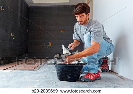 Bricklayer applying tile adhesive for tiling. Construction of residential building. Donostia. San Sebastian. Gipuzkoa. Basque Country. Spain. View Large Photo Image Stock Photo - Bricklayer applying tile adhesive for tiling. Construction of residential building. Donostia. San Sebastian. Gipuzkoa. Basque Country. Spain.. Fotosearch