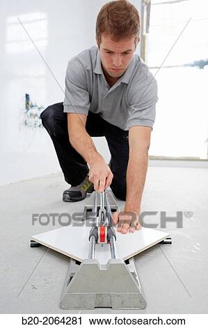 Bricklayer cutting tile. Manual tile cutter. Construction Industry. View Large Photo Image Stock Image - Bricklayer cutting tile. Manual tile cutter. Construction Industry.. Fotosearch