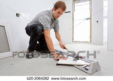 Bricklayer cutting tile. Manual tile cutter. Construction Industry. View Large Photo Image Stock Image - Bricklayer cutting tile. Manual tile cutter. Construction Industry.. Fotosearch