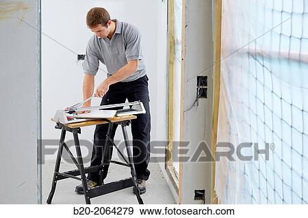 Bricklayer cutting tile. Manual tile cutter. Construction Industry. View Large Photo Image Stock Photo - Bricklayer cutting tile. Manual tile cutter. Construction Industry.. Fotosearch