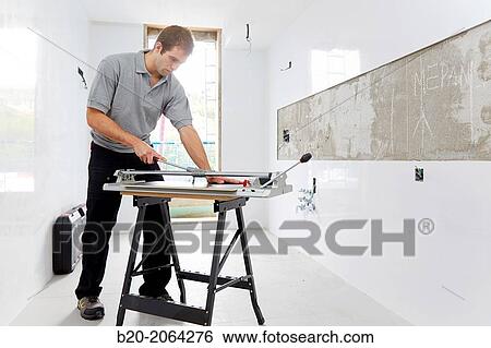 Bricklayer cutting tile. Manual tile cutter. Construction Industry. View Large Photo Image Stock Photograph - Bricklayer cutting tile. Manual tile cutter. Construction Industry.. Fotosearch