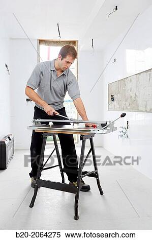 Bricklayer cutting tile. Manual tile cutter. Construction Industry. View Large Photo Image Stock Photography - Bricklayer cutting tile. Manual tile cutter. Construction Industry.. Fotosearch