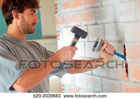 Bricklayer making a groove in the brick wall to place electrical wires. Hammer and chisel hand tools. Construction. Building work. Donostia. San Sebastian. Gipuzkoa. Basque Country. Spain. View Large Photo Image Stock Image - Bricklayer making a groove in the brick wall to place electrical wires. Hammer and chisel hand tools. Construction. Building work. Donostia. San Sebastian. Gipuzkoa. Basque Country. Spain.. Fotosearch