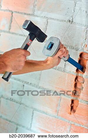 Bricklayer making a groove in the brick wall to place electrical wires. Hammer and chisel hand tools. Construction. Building work. Donostia. San Sebastian. Gipuzkoa. Basque Country. Spain. View Large Photo Image Stock Photo - Bricklayer making a groove in the brick wall to place electrical wires. Hammer and chisel hand tools. Construction. Building work. Donostia. San Sebastian. Gipuzkoa. Basque Country. Spain.. Fotosearch