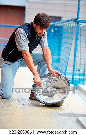 Bricklayer making cement mortar. Construction of residential building. Donostia. San Sebastian. Gipuzkoa. Basque Country. Spain. View Large Photo Image Stock Image - Bricklayer making cement mortar. Construction of residential building. Donostia. San Sebastian. Gipuzkoa. Basque Country. Spain.. Fotosearch
