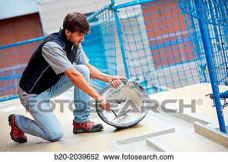 Bricklayer making cement mortar. Construction of residential building. Donostia. San Sebastian. Gipuzkoa. Basque Country. Spain. View Large Photo Image Stock Image - Bricklayer making cement mortar. Construction of residential building. Donostia. San Sebastian. Gipuzkoa. Basque Country. Spain.. Fotosearch