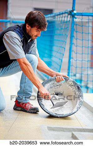 Bricklayer making cement mortar. Construction of residential building. Donostia. San Sebastian. Gipuzkoa. Basque Country. Spain. View Large Photo Image Stock Image - Bricklayer making cement mortar. Construction of residential building. Donostia. San Sebastian. Gipuzkoa. Basque Country. Spain.. Fotosearch