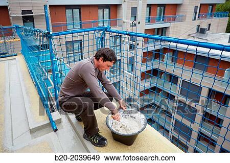 Bricklayer making cement mortar. Construction of residential building. Donostia. San Sebastian. Gipuzkoa. Basque Country. Spain. View Large Photo Image Stock Photo - Bricklayer making cement mortar. Construction of residential building. Donostia. San Sebastian. Gipuzkoa. Basque Country. Spain.. Fotosearch