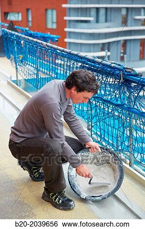 Bricklayer making cement mortar. Construction of residential building. Donostia. San Sebastian. Gipuzkoa. Basque Country. Spain. View Large Photo Image Stock Photograph - Bricklayer making cement mortar. Construction of residential building. Donostia. San Sebastian. Gipuzkoa. Basque Country. Spain.. Fotosearch