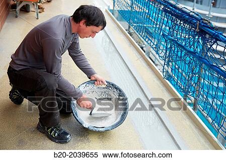 Stock Photography - Bricklayer making cement mortar. Construction of residential building. Donostia. San Sebastian. Gipuzkoa. Basque Country. Spain.. Fotosearch