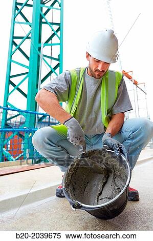 Bricklayer making cement mortar. Construction of residential building. Donostia. San Sebastian. Gipuzkoa. Basque Country. Spain. View Large Photo Image Stock Photography - Bricklayer making cement mortar. Construction of residential building. Donostia. San Sebastian. Gipuzkoa. Basque Country. Spain.. Fotosearch