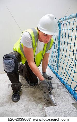 Stock Photo - Bricklayer with a trowel. Construction of residential building. Donostia. San Sebastian. Gipuzkoa. Basque Country. Spain.. Fotosearch