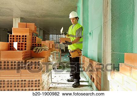 Bricklayer with trowel making a brick wall, Mason with personal protective equipment, PPE, Apartment Building under construction, Donostia, San Sebastian, Gipuzkoa, Basque Country, Spain View Large Photo Image Stock Image - Bricklayer with trowel making a brick wall, Mason with personal protective equipment, PPE, Apartment Building under construction, Donostia, San Sebastian, Gipuzkoa, Basque Country, Spain. Fotosearch