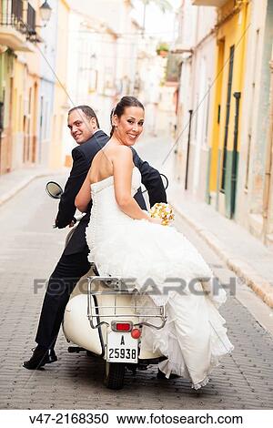 Bridal couple on their journey with a Vespa View Large Photo Image Stock Image - Bridal couple on their journey with a Vespa. Fotosearch