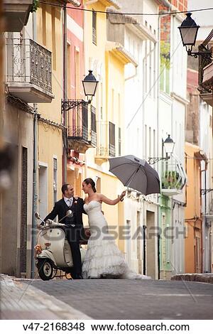 Bridal couple on their journey with a Vespa View Large Photo Image Stock Photo - Bridal couple on their journey with a Vespa. Fotosearch