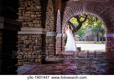 Bridal portrait - A young bride in wedding dress posing at historical looking building at Garner State Park, Concan, Texas, USA, Female Caucasian, 23 years old View Large Photo Image Stock Photo - Bridal portrait - A young bride in wedding dress posing at historical looking building at Garner State Park, Concan, Texas, USA, Female Caucasian, 23 years old. Fotosearch