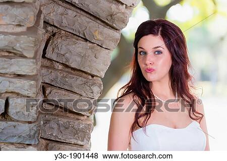 Stock Photo - Bridal portrait - A young bride in wedding dress posing at historical looking building at Garner State Park, Concan, Texas, USA, Female Caucasian, 23 years old. Fotosearch