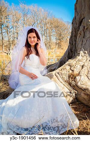 Bridal portrait - A young bride in wedding dress posing at the Frio River near Concan, Texas, USA, Female Caucasian, 23 years old View Large Photo Image Stock Photograph - Bridal portrait - A young bride in wedding dress posing at the Frio River near Concan, Texas, USA, Female Caucasian, 23 years old. Fotosearch