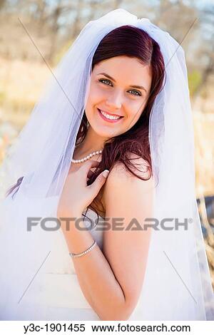 Stock Photography - Bridal portrait - A young bride in wedding dress posing at the Frio River near Concan, Texas, USA, Female Caucasian, 23 years old. Fotosearch