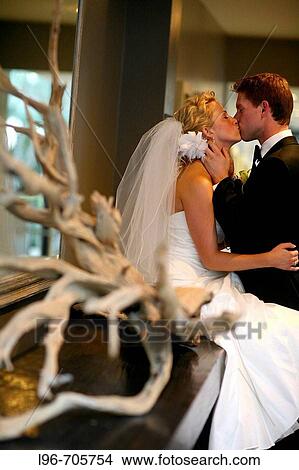 bride and groom alone after wedding, kissing and embracing View Large Photo Image Picture - bride and groom alone after wedding, kissing and embracing. Fotosearch