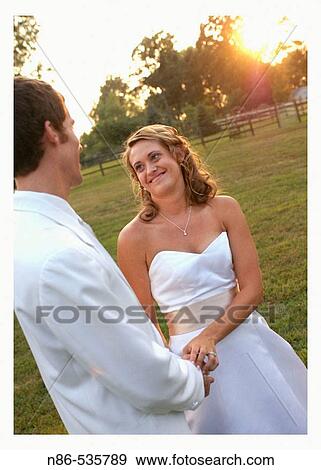 Stock Photo - Bride and groom at altar outdoors. Fotosearch