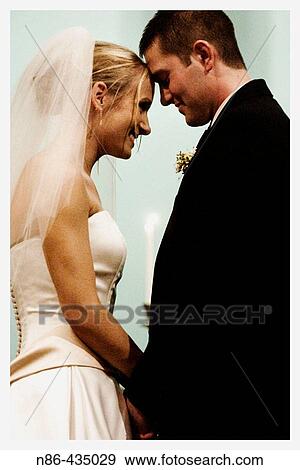 Bride and groom at altar View Large Photo Image Stock Photo - Bride and groom at altar. Fotosearch