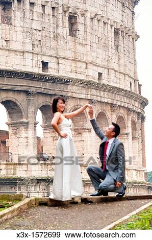 Stock Photo - Bride and groom at the Roman Coliseum Rome Italy. Fotosearch