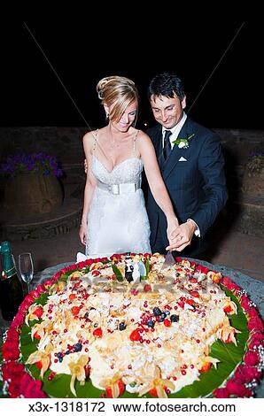Bride and groom cutting the wedding cake View Large Photo Image Stock Image - Bride and groom cutting the wedding cake. Fotosearch