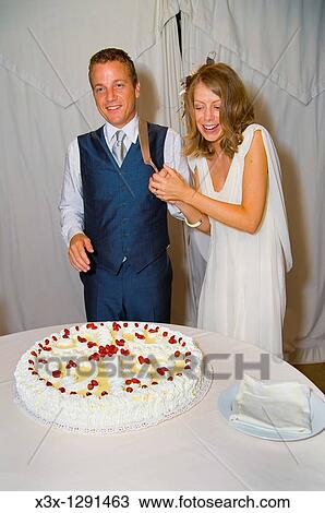 Bride and groom cutting wedding cake View Large Photo Image Stock Image - Bride and groom cutting wedding cake. Fotosearch