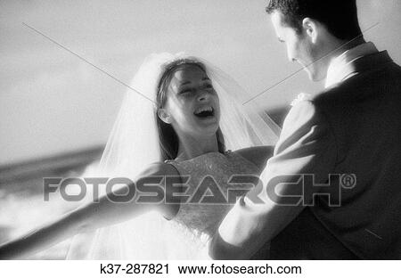Bride and groom dancing on beach View Large Photo Image Stock Image - Bride and groom dancing on beach. Fotosearch