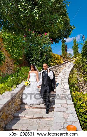 Bride and groom descending stairs together View Large Photo Image Stock Image - Bride and groom descending stairs together. Fotosearch