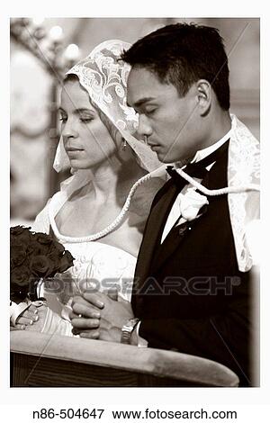 Stock Photo - Bride and groom during ceremony. Fotosearch