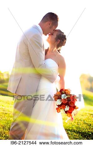 bride and groom embracing after wedding in a garden View Large Photo Image Picture - bride and groom embracing after wedding in a garden. Fotosearch