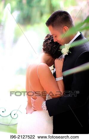 bride and groom enjoying a moment, embracing after the wedding in a garden setting View Large Photo Image Stock Image - bride and groom enjoying a moment, embracing after the wedding in a garden setting. Fotosearch